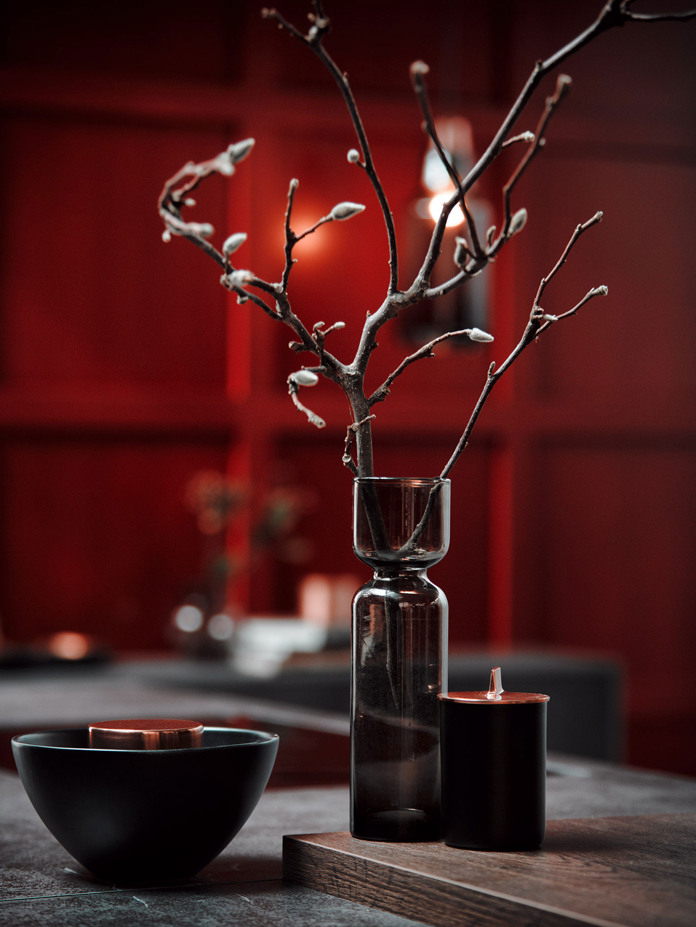 AV8000_Iron_grey_4 Elegante Vase mit Zweigen und Kerze auf Tisch